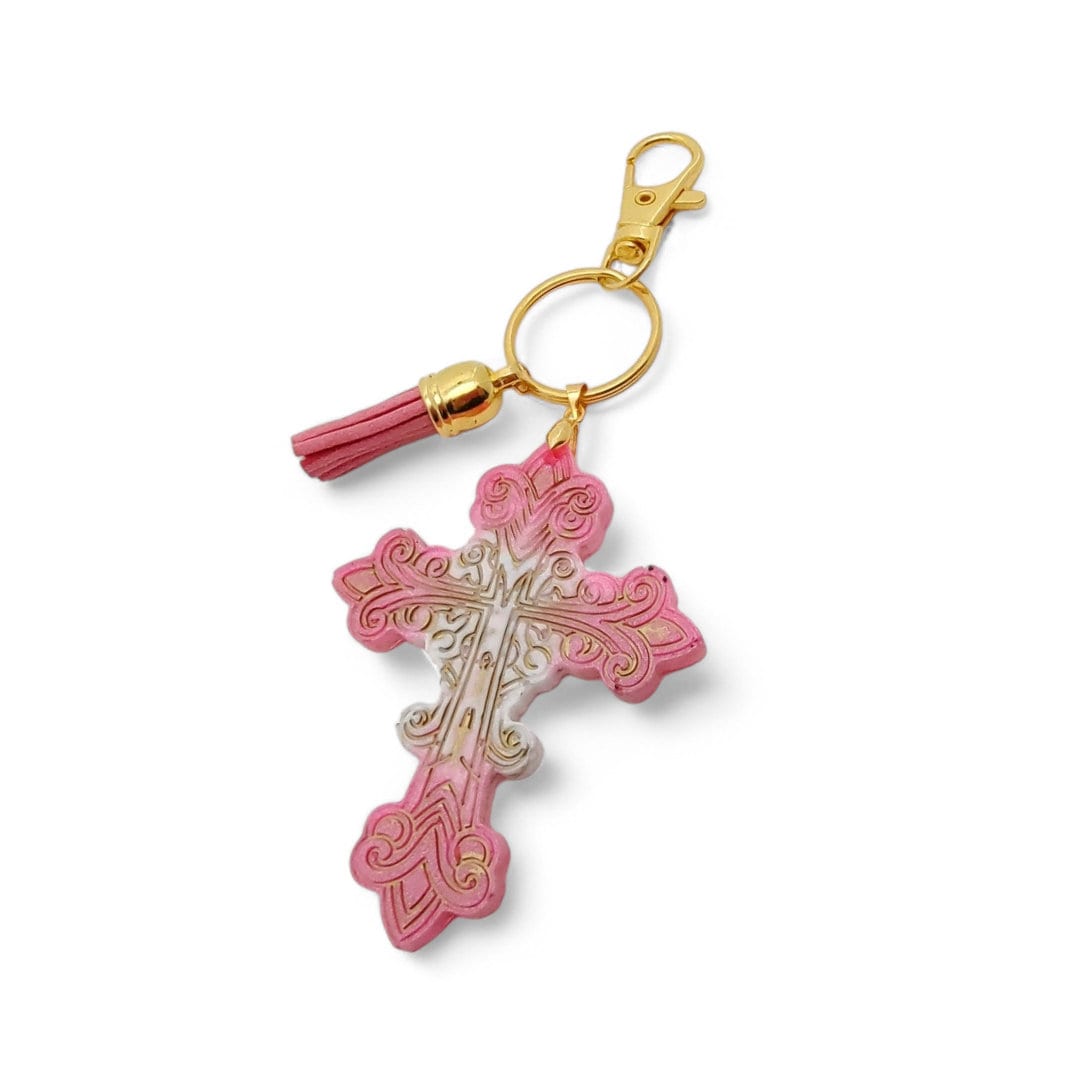 Schlüsselanhänger Kreuz "Glück" aus Epoxidharz mit einer kleinen Quaste und einem Karabiner